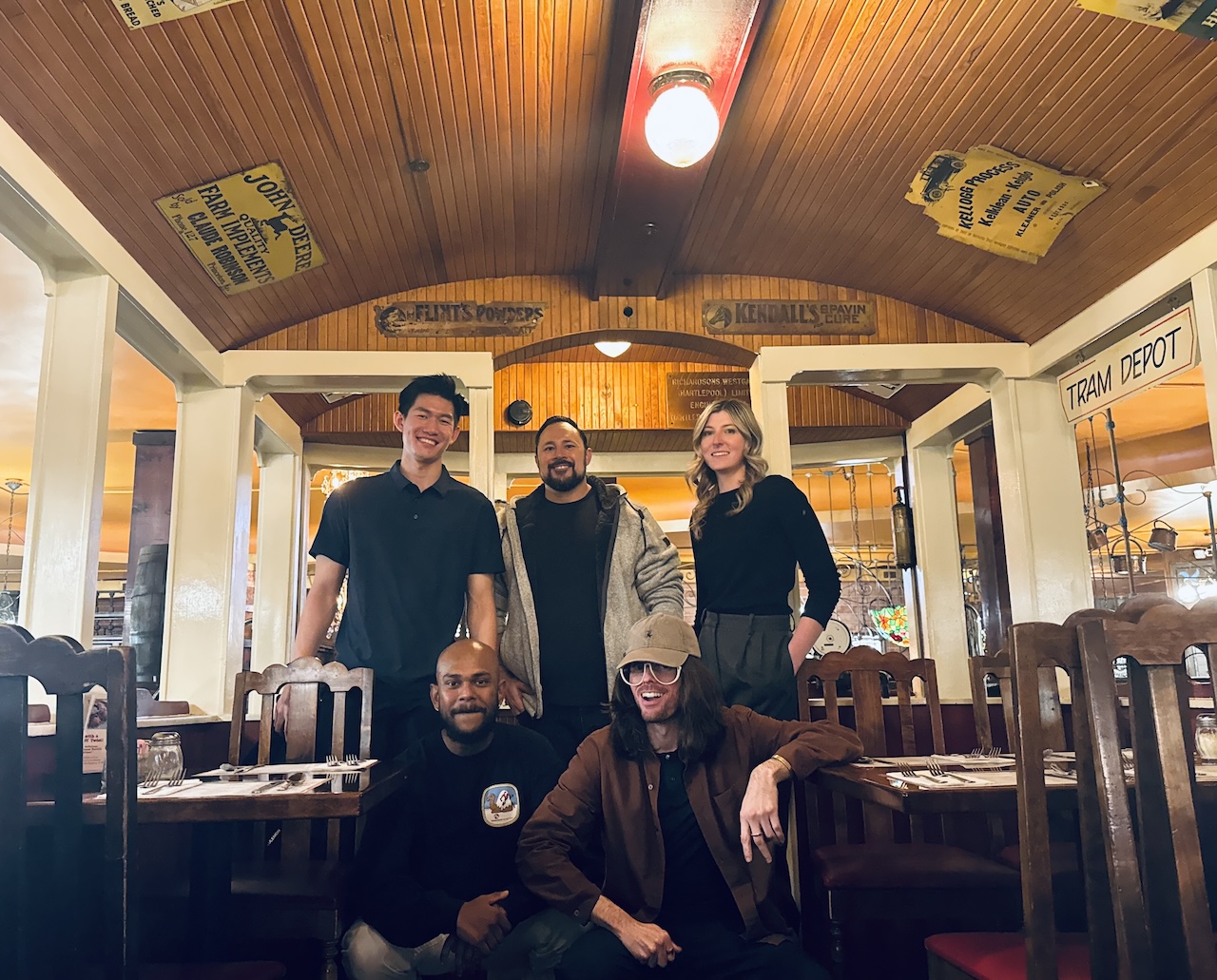 MS-AIB student Tyler Lai at a restaurant with the other four students in his capstone project group