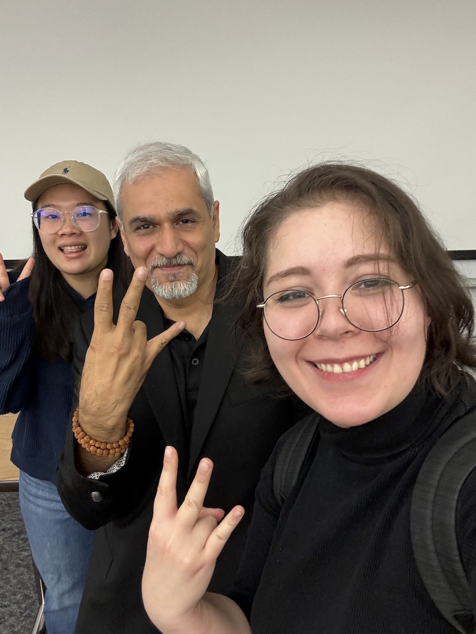 MS-SCM student Bethany Farmer with others from the program making the ASU pitchfork hand symbol