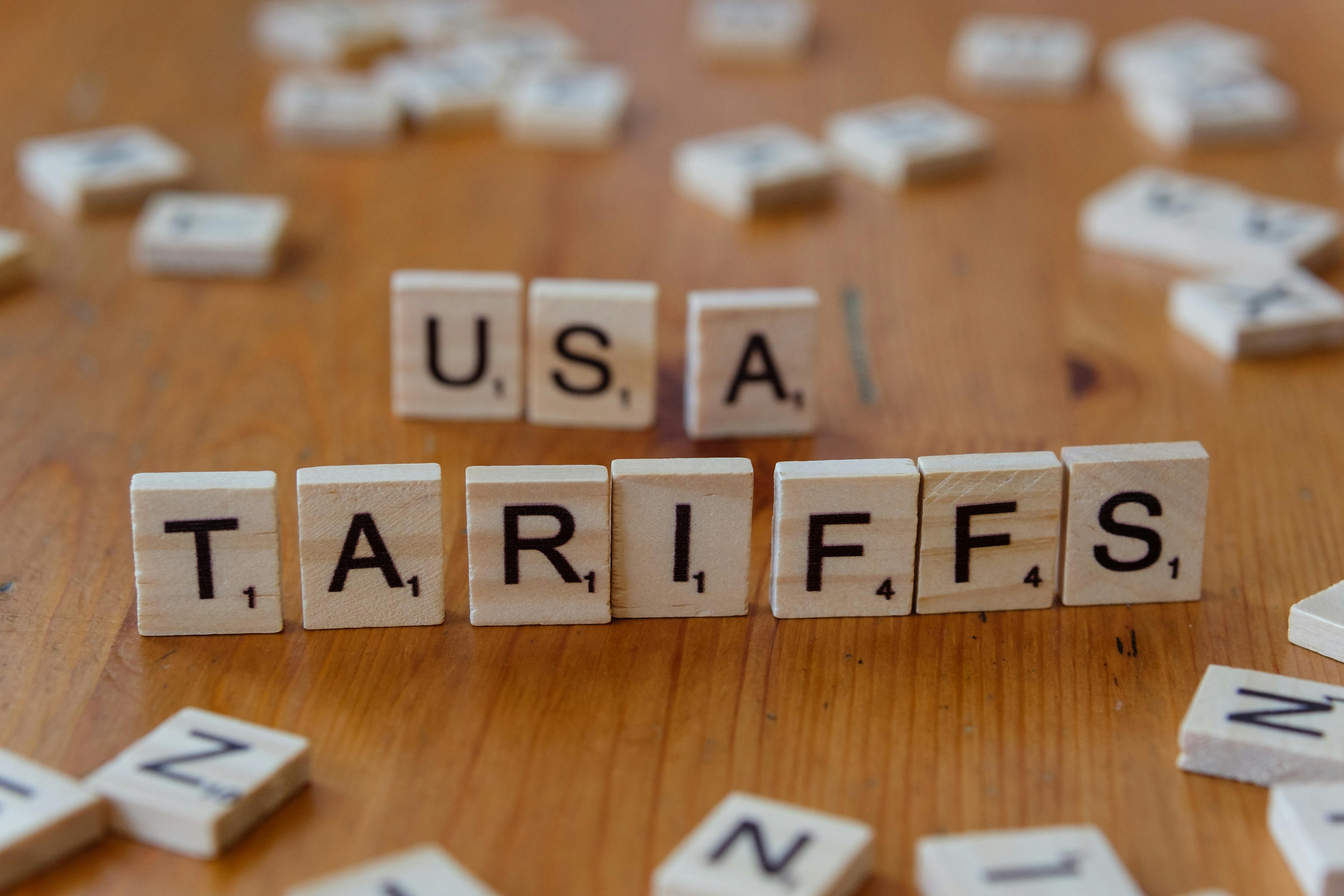 Scrabble letters spelling the words "USA" and "Tariffs"